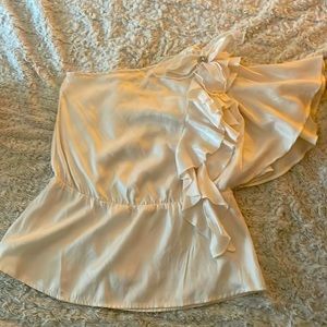 Small elegant and dressy Blouse with a bejeweled broach. Cream color.